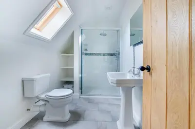 a bathroom with a toilet and a shower and a sink at 1 Bed in Sudbourne oc-tgs in Sudbourne