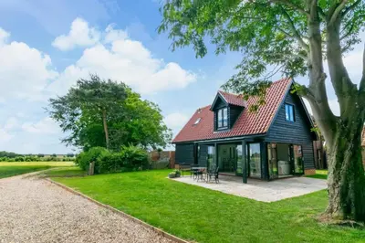 a house with a red roof and a yard at 1 Bed in Sudbourne oc-tgs in Sudbourne