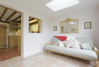 a living room with a couch and a mirror at 1 Bed in Great Bealings oc-rosec in Bealings