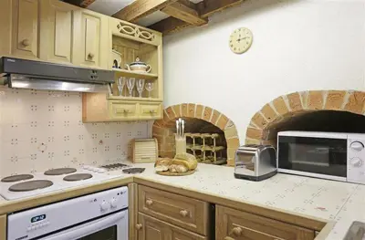 a kitchen with a counter with a stove and a microwave at 1 Bed in Great Bealings oc-rosec in Bealings