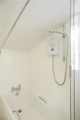 a white bathroom with a shower and a sink at 1 Bed in Great Bealings oc-rosec in Bealings