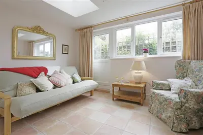 a living room with a couch and a chair at 1 Bed in Great Bealings oc-rosec in Bealings