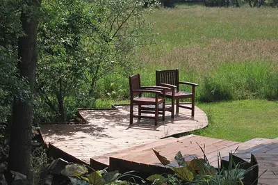 two chairs and a table on a wooden deck at 1 Bed in Woodbridge oc-stabu in Ufford