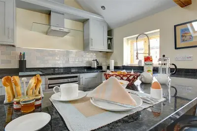 a kitchen with a counter top with dishes on it at 1 Bed in Woodbridge oc-stabu in Ufford