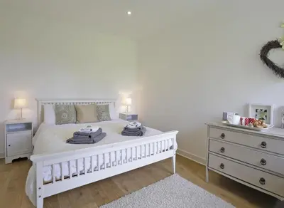 a white bedroom with a white bed and a dresser at 1 Bed in Saxmundham oc-stab in Friston