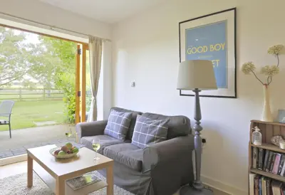 a living room with a couch and a table at 1 Bed in Saxmundham oc-stab in Friston