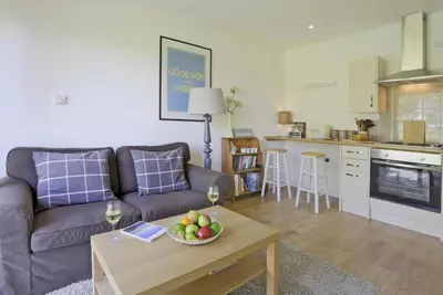 a living room with a couch and a table with a bowl of fruit at 1 Bed in Saxmundham oc-stab in Friston