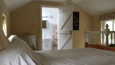a bedroom with a bed and a sliding door at The Old Post Office, Hilton in Huntingdon