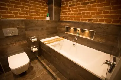 a bathroom with a toilet and a bath tub at Channels Retreat in Chelmsford