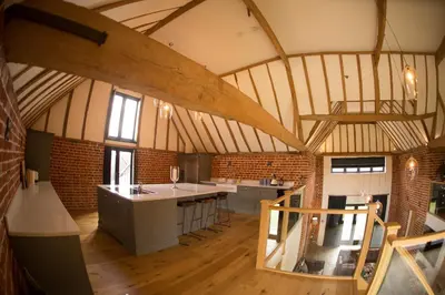 an attic room with a kitchen and a kitchen island at Channels Retreat in Chelmsford