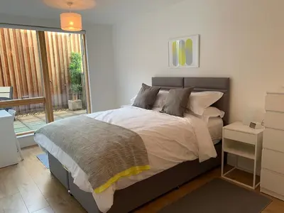 a bedroom with a large bed and a window at Toothbrush Apartments - Ipswich Waterfront - Quayside in Ipswich