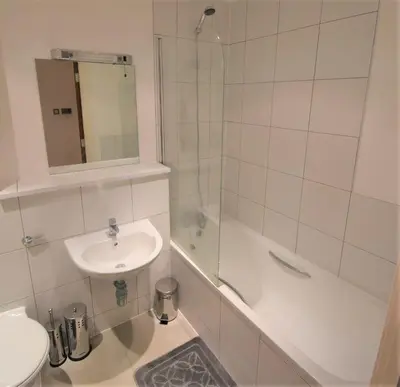 a bathroom with a sink and a toilet and a shower at Toothbrush Apartments - Ipswich Waterfront - Quayside in Ipswich