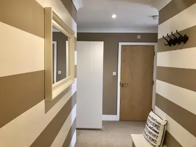 a hallway with striped walls and a door at Toothbrush Apartments - Ipswich Waterfront - Anchor St in Ipswich