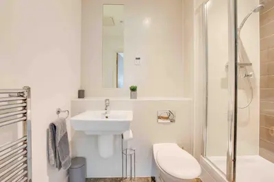 a bathroom with a sink and a toilet and a shower at Niche Parkview Apartments in Brentwood
