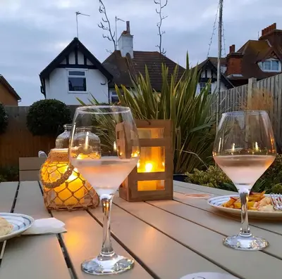 two glasses of white wine sitting on a table at Viva Guest House in Clacton-on-Sea