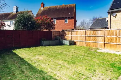 a yard with a wooden fence and a house at Comfortable Colchester Home in Colchester