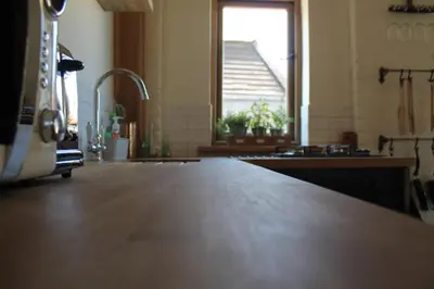 a kitchen with a wooden counter top and a window at The Dovecote - unique self-contained 1bed renovated barn in Saffron Walden