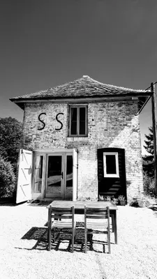a stone building with a bench in front of it at The Dovecote - unique self-contained 1bed renovated barn in Saffron Walden