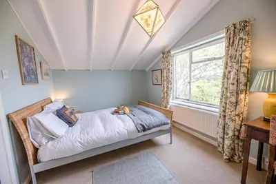 a bedroom with a bed and a window at The Shealing, Waldringfield in Waldringfield