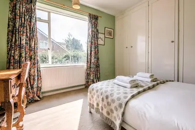 a bedroom with a bed and a window at The Shealing, Waldringfield in Waldringfield