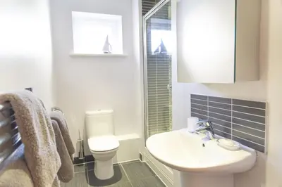 a bathroom with a white toilet and a sink at Citystay Living - Marino Place in Cambridge