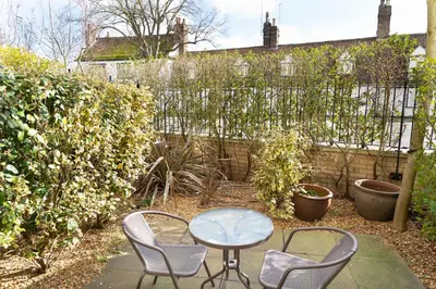 a patio with a table and chairs and a fence at Citystay Living - Marino Place in Cambridge