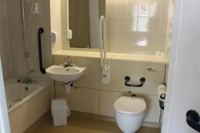 a bathroom with a toilet and a sink at Redwings Lodge Baldock in Baldock