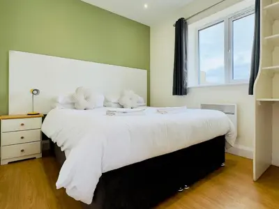a bedroom with a large white bed with teddy bears on it at Fox Lodge - Uk30605 in Pidley