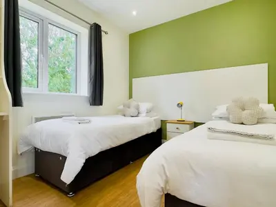 a bedroom with two beds and two windows at Fox Lodge - Uk30605 in Pidley