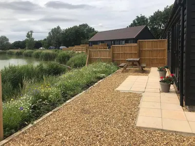 a garden with a picnic table next to a pond at Fox Lodge - Uk30605 in Pidley