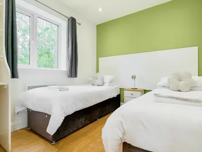 a bedroom with two beds and a window at Hare Lodge - Uk30604 in Pidley