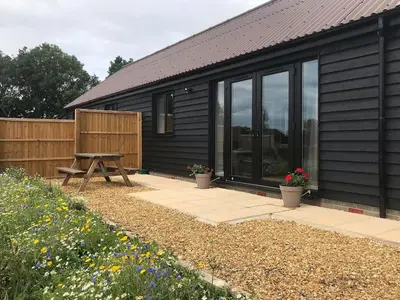 a house with a picnic table in front of it at Hare Lodge - Uk30604 in Pidley
