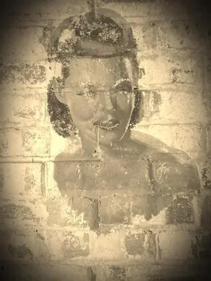 a painting of a woman on a brick wall at wingate cottage in Southburgh