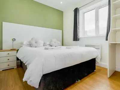 a bedroom with a large white bed with white pillows at Badger Lodge - Uk30603 in Pidley