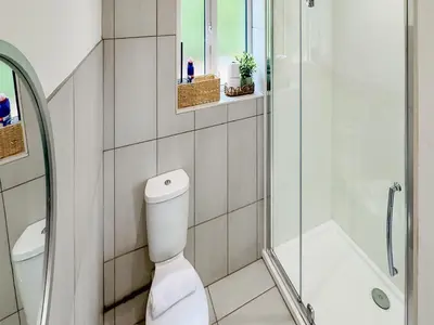 a white bathroom with a toilet and a shower at Badger Lodge - Uk30603 in Pidley
