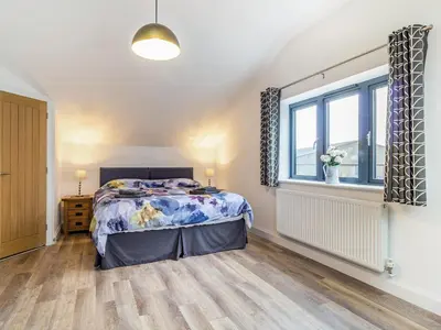 a bedroom with a bed and a window at Fenside Way in Wicken