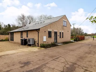 a small brick building with a gray roof at Fenside Way in Wicken