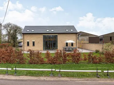 a large brick house with a black roof at Fenside Way in Wicken