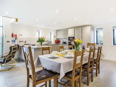 a kitchen and dining room with a table and chairs at Fenside Way in Wicken