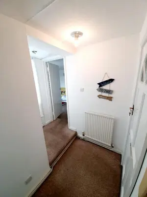 an empty hallway with a room with a boat on the wall at Rayleigh Town Centre 2 Bedroom Apartment in Rayleigh