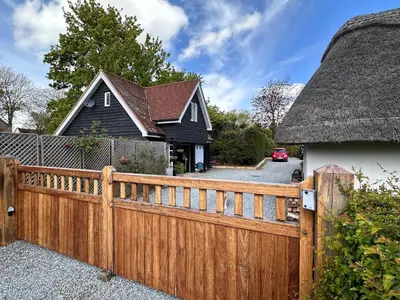 a wooden fence in front of a house at The Cottage get away in Saffron Walden