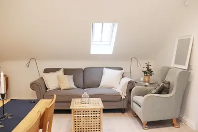 a living room with a couch and two chairs at The Cottage get away in Saffron Walden