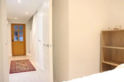 a bedroom with a door leading to a hallway at The Cottage get away in Saffron Walden