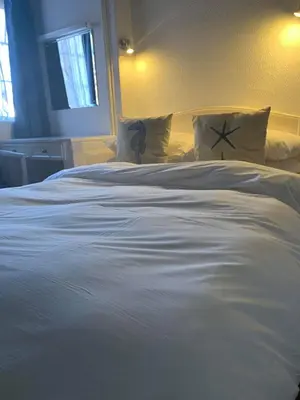 a large white bed with pillows in a bedroom at Ye Olde White Harte Hotel in Burnham on Crouch