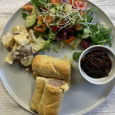 a plate of food with a salad and a sandwich at Ye Olde White Harte Hotel in Burnham on Crouch