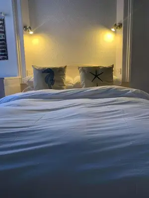 a large white bed with pillows in a bedroom at Ye Olde White Harte Hotel in Burnham on Crouch