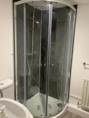 a shower with a glass door in a bathroom at Appletree Cottages in Mildenhall