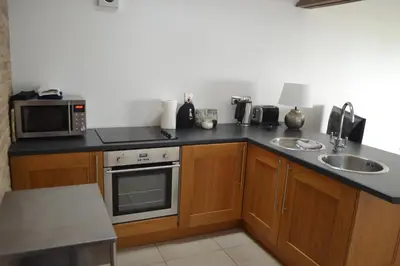 a kitchen with a sink and a microwave at Appletree Cottages in Mildenhall