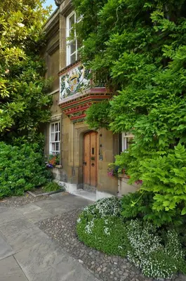 a building with a clock on the side of it at Christ's College Cambridge in Cambridge