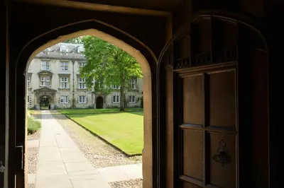 an open door to a large building with a yard at Christ's College Cambridge in Cambridge